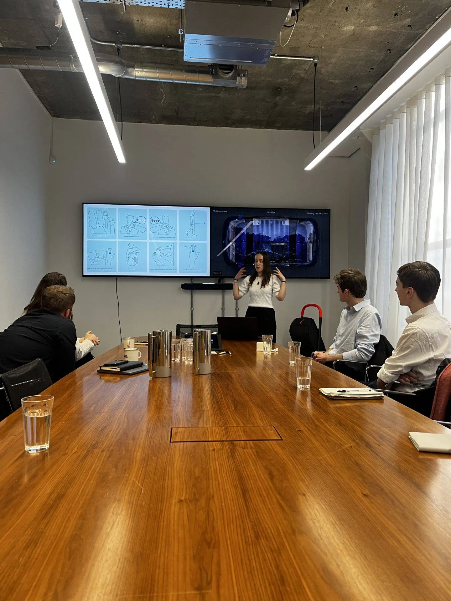 A student presenting a design concept to a panel.