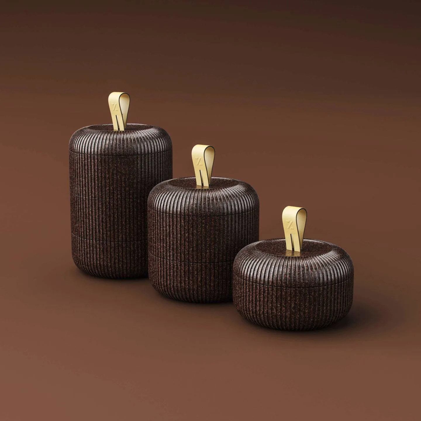Three stacked brown bento box style containers in different sizes on a light brown background