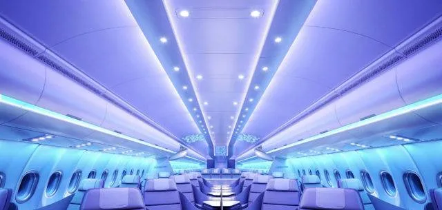 Business Class cabin on the Airbus A330neo at night time, with soothing blue and purple lighting