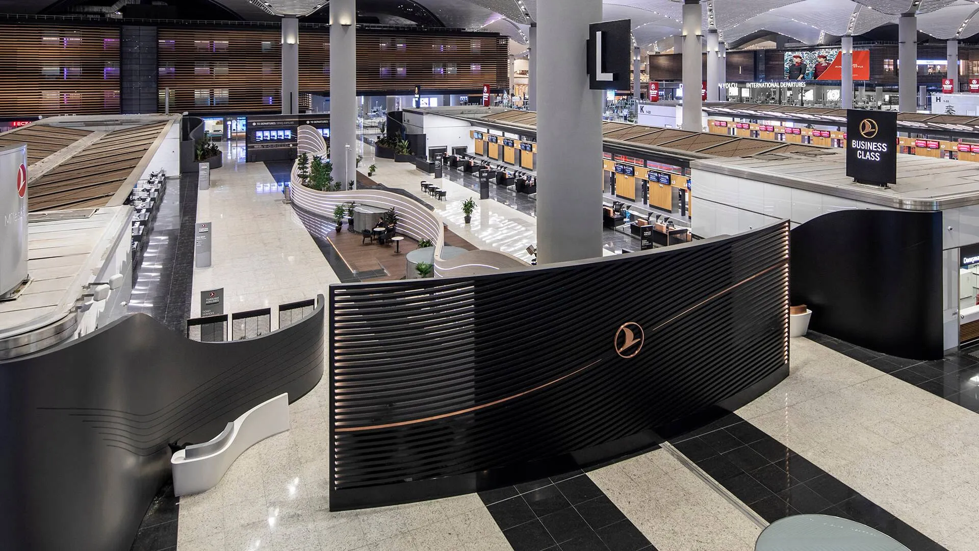 Overhead view of the vast New Istanbul Airport, featuring an imposing Business Class wall panel indicating dedicated check in area