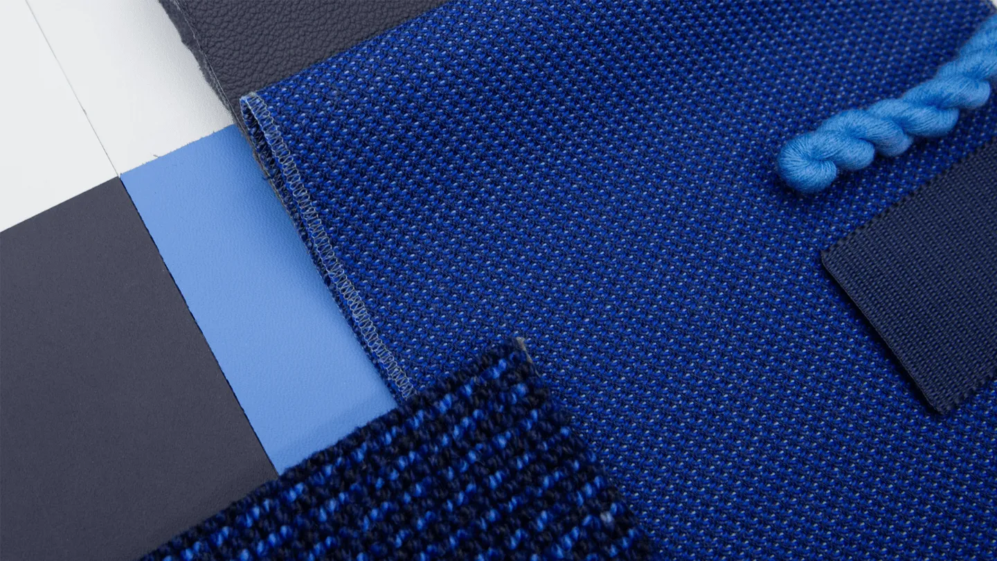 Discover Airlines cabin interior with blue seats and patterned headrests, designed by PriestmanGoode.