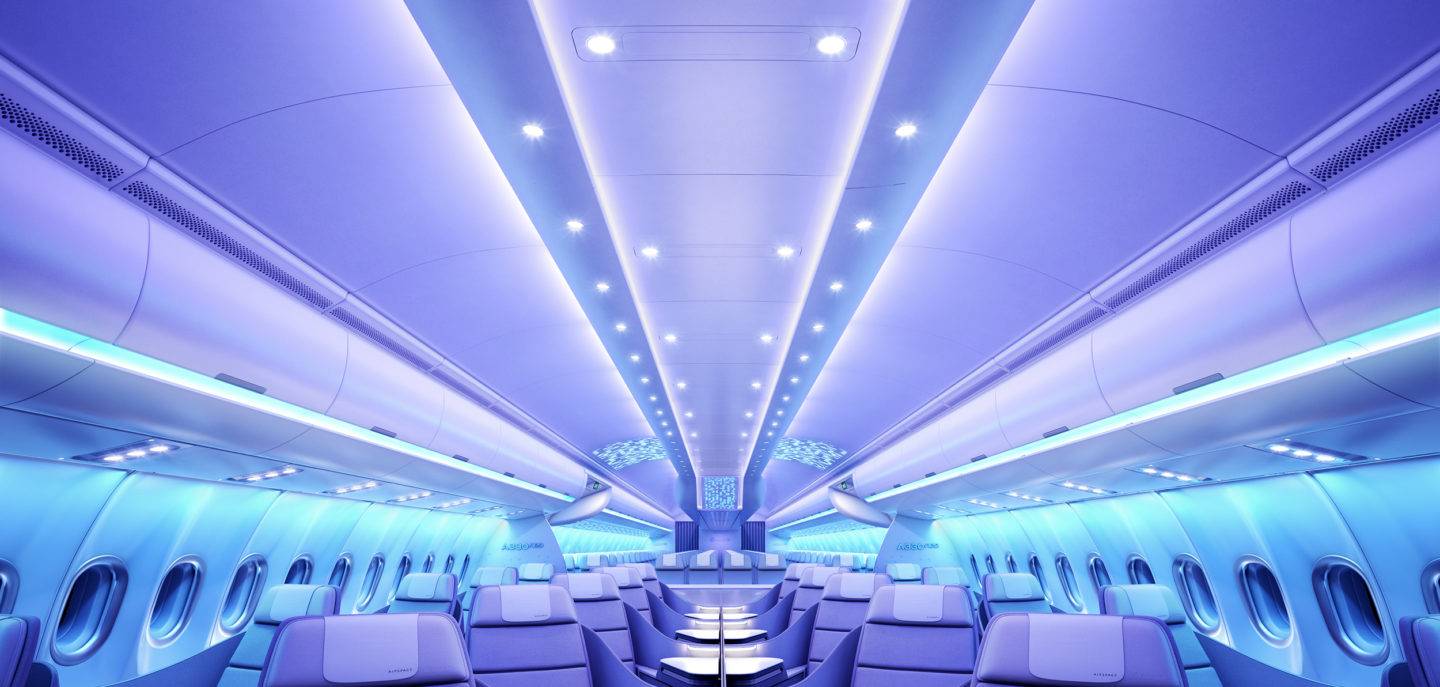 Business Class cabin on the Airbus A330neo at night time, with soothing blue and purple lighting