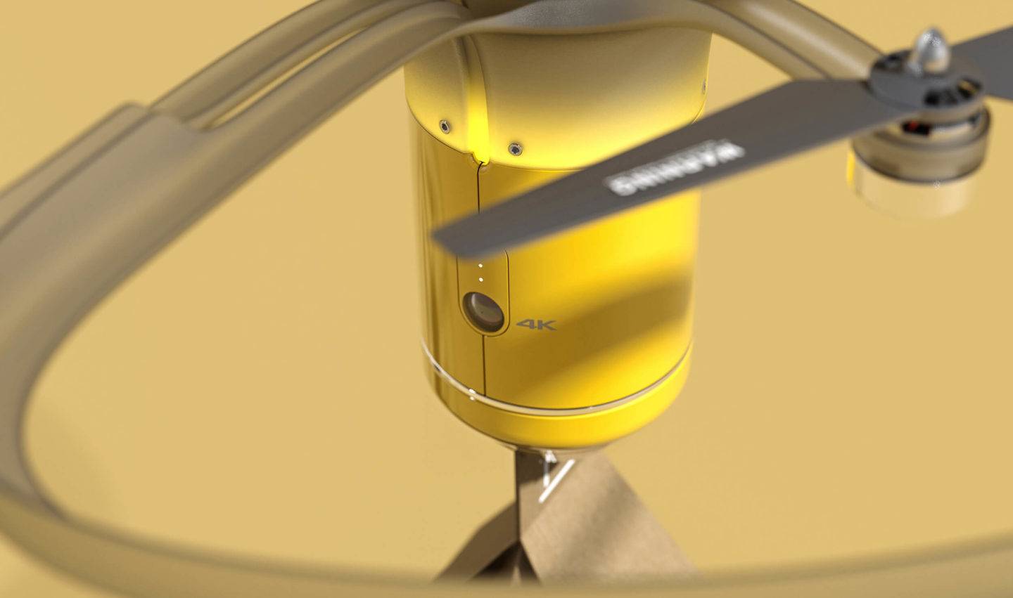 Close up view of a drone carrying a parcel, against a yellow backdrop