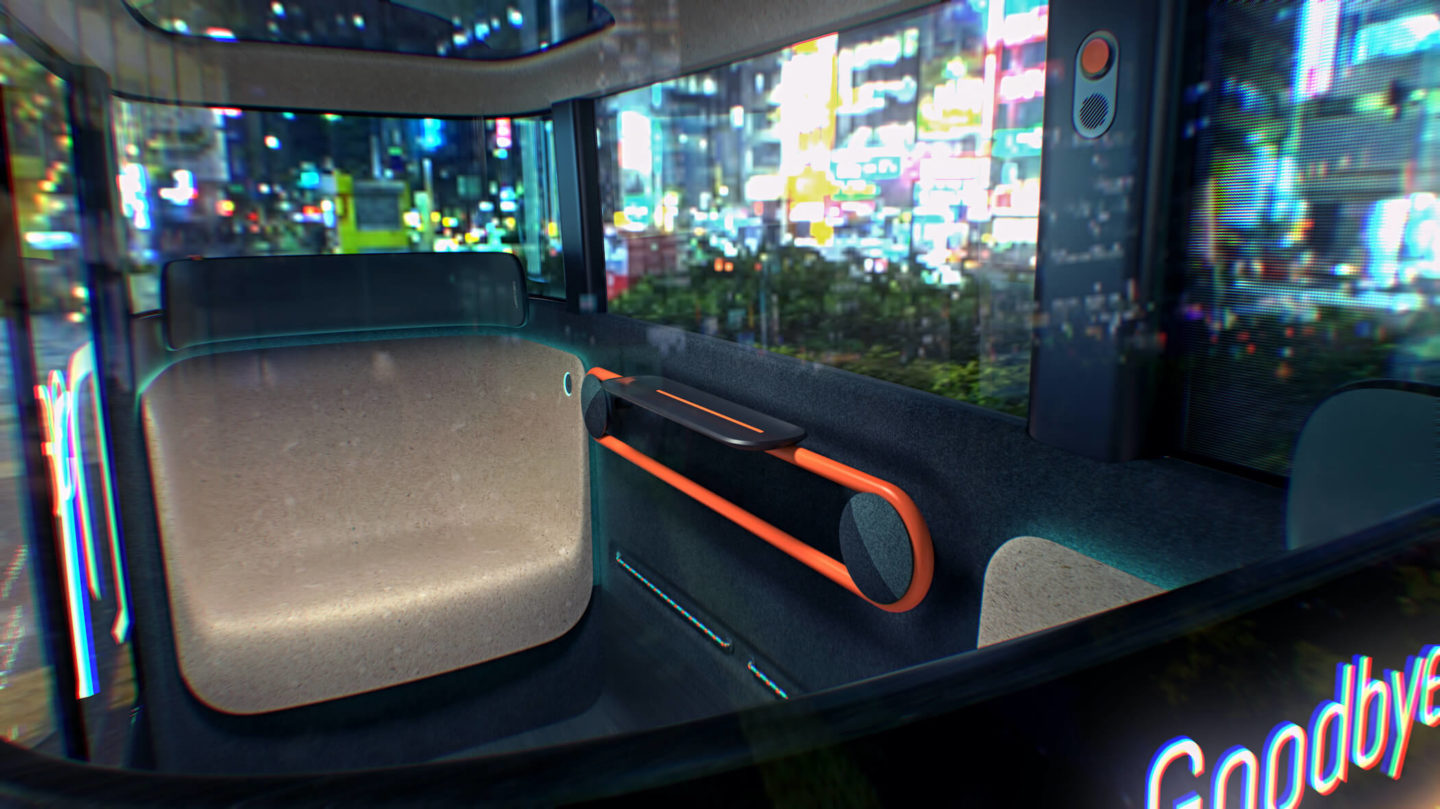 The Dromos autonomous vehicle interior, the bright lights of a city can be seen outside of the vehicle windows