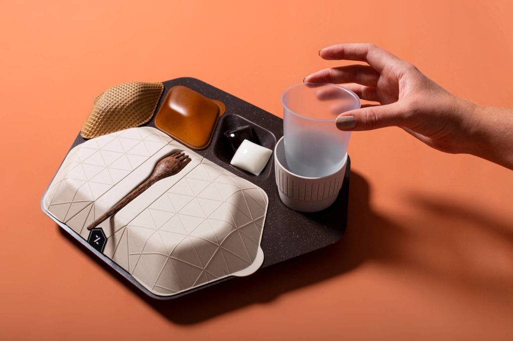 An airline mealtray made of sustainable materials, including wafer biscuit, algae, coffee grounds and coconut wood
