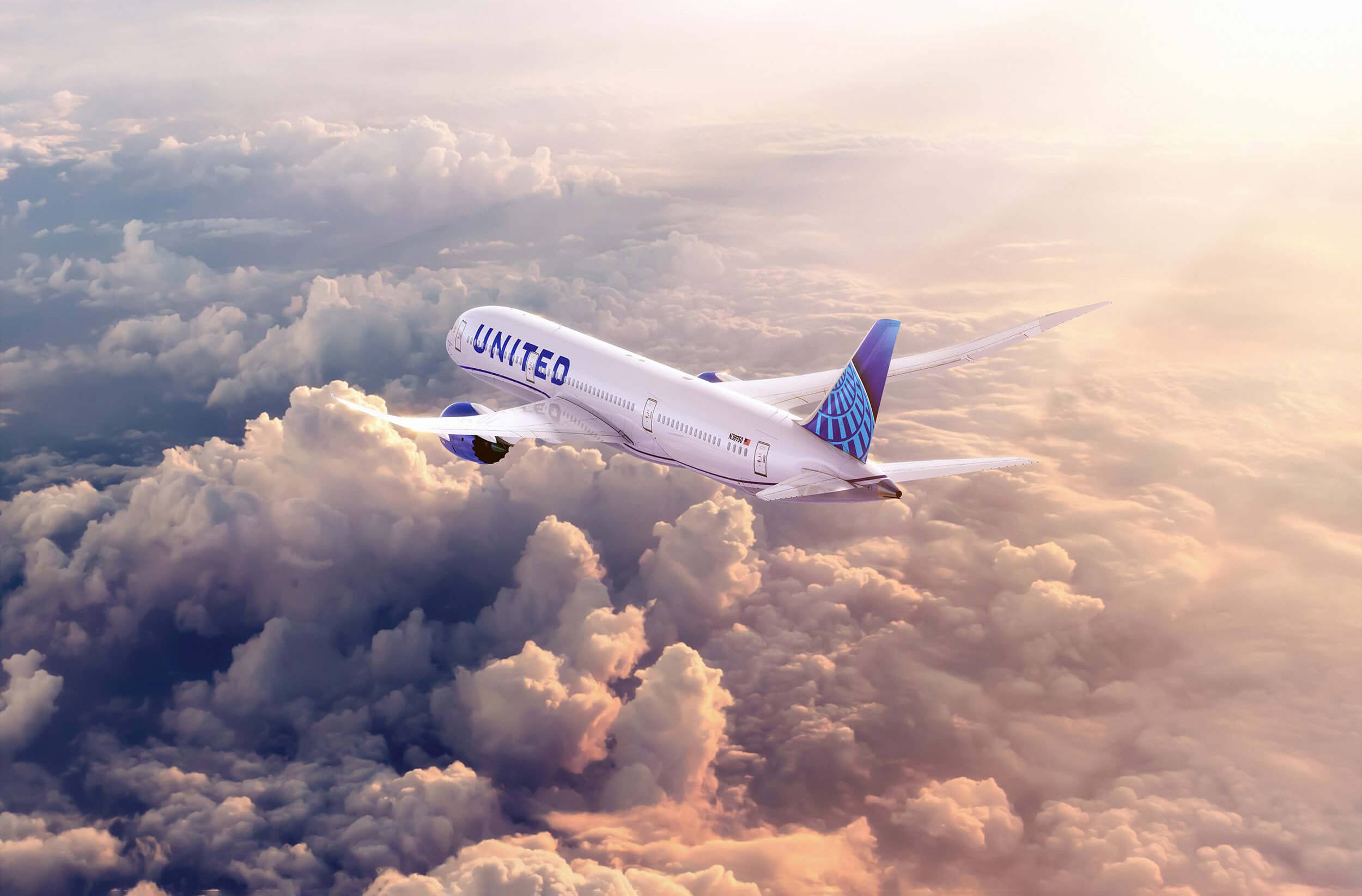 United Airlines plane flying above the clouds