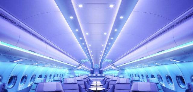 Business Class cabin on the Airbus A330neo at night time, with soothing blue and purple lighting