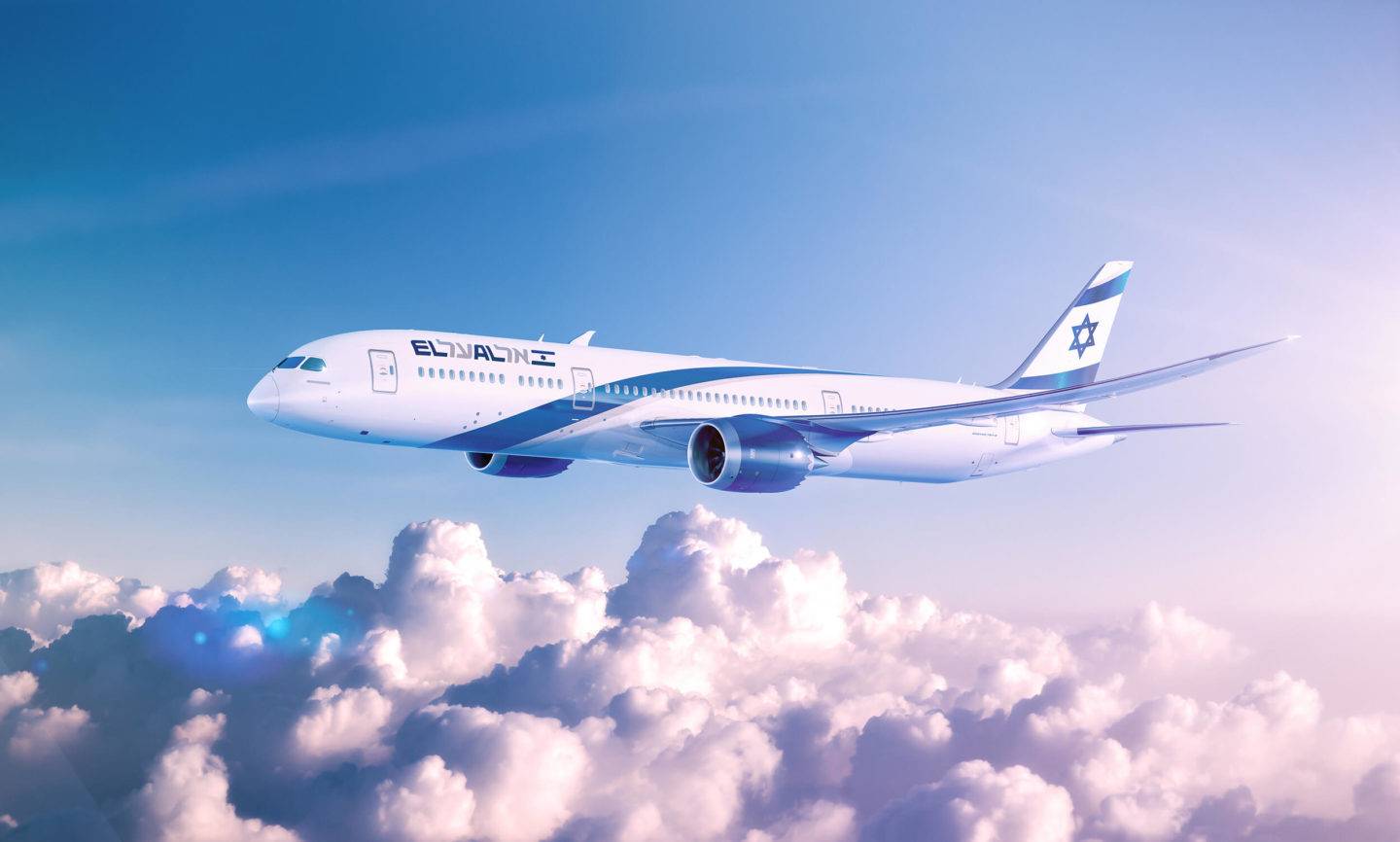 El al aircraft flying above clouds