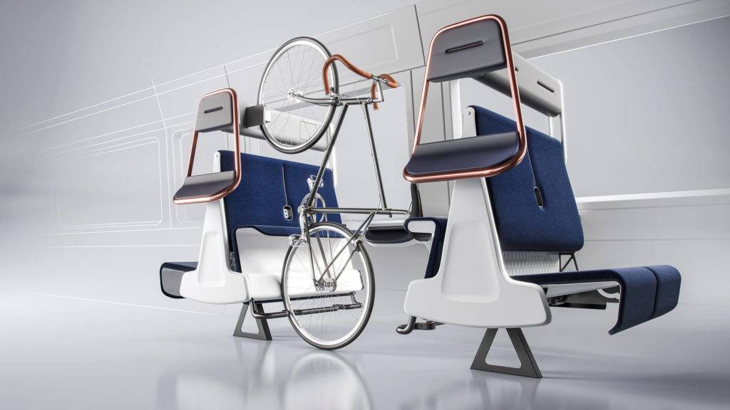 A group of four train seats facing one another has been adapted so the seats flip eat to allow the space to be used for bicycle storage