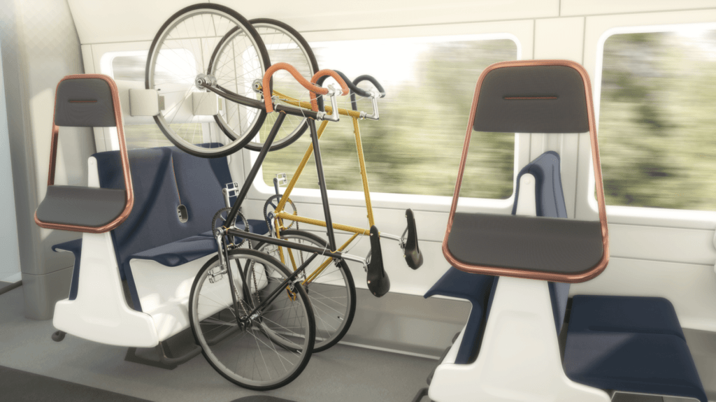 A group of four train seats facing one another has been adapted so the seats flip eat to allow the space to be used for bicycle storage