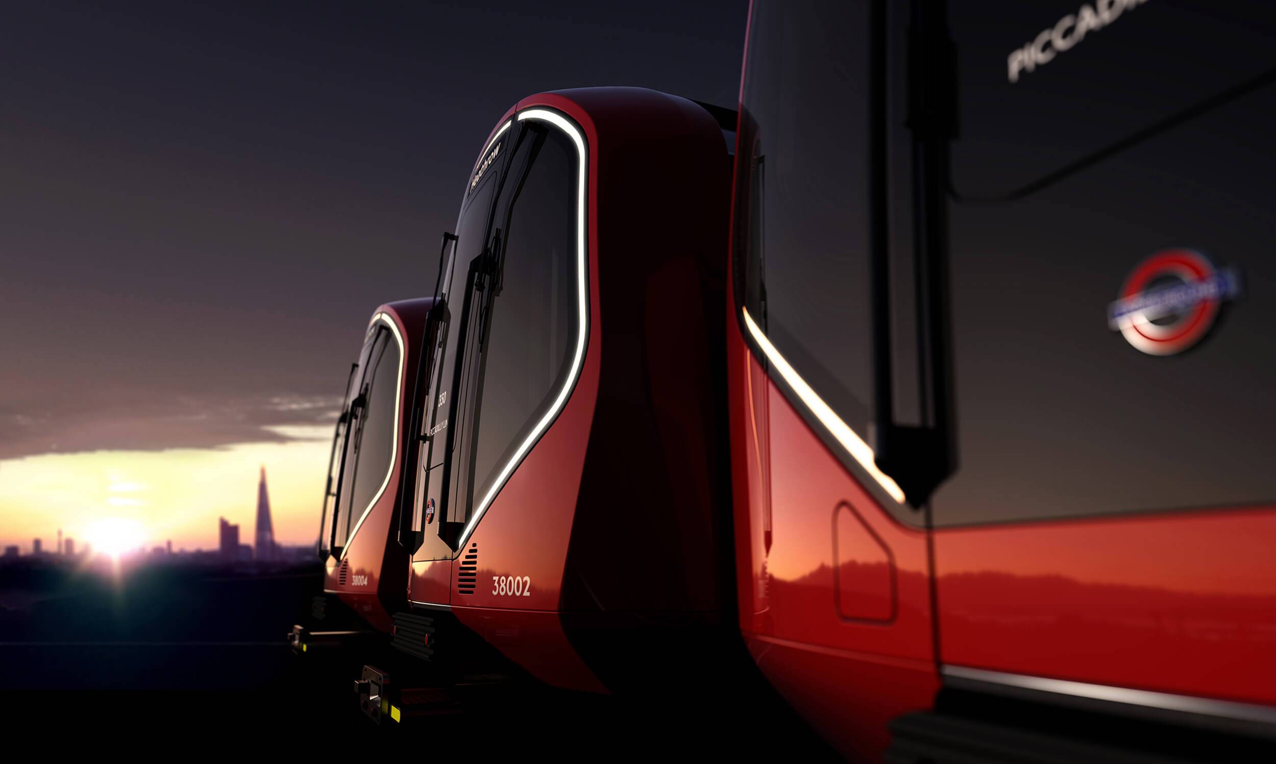 The front of three London Underground train carriages seen at Dawn. Buildings can be seen in the distance