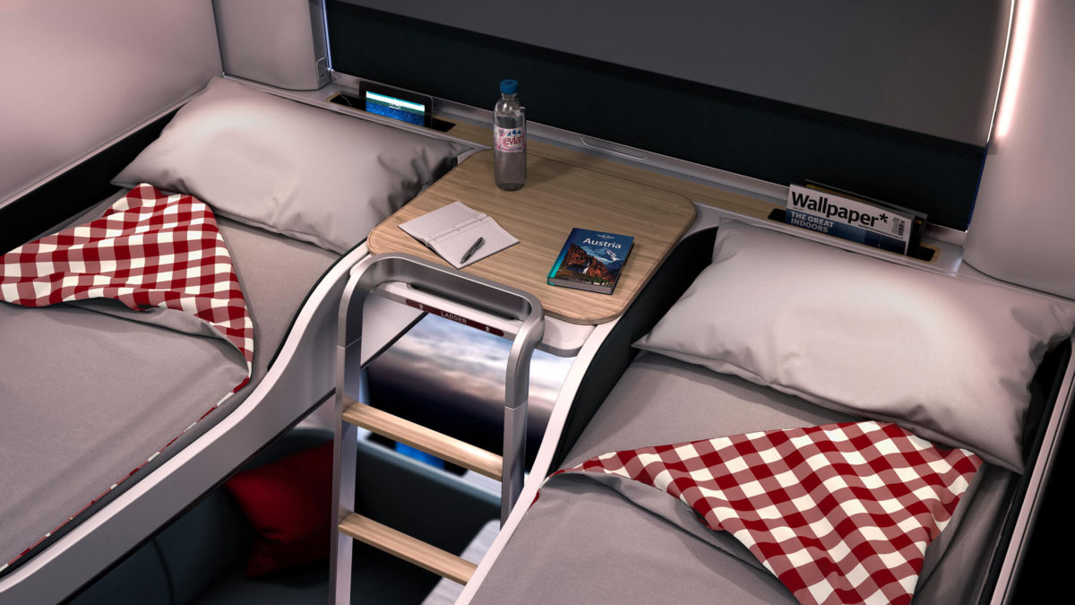 Two top bunk beds in a night train carriage, with a table and ladder between them