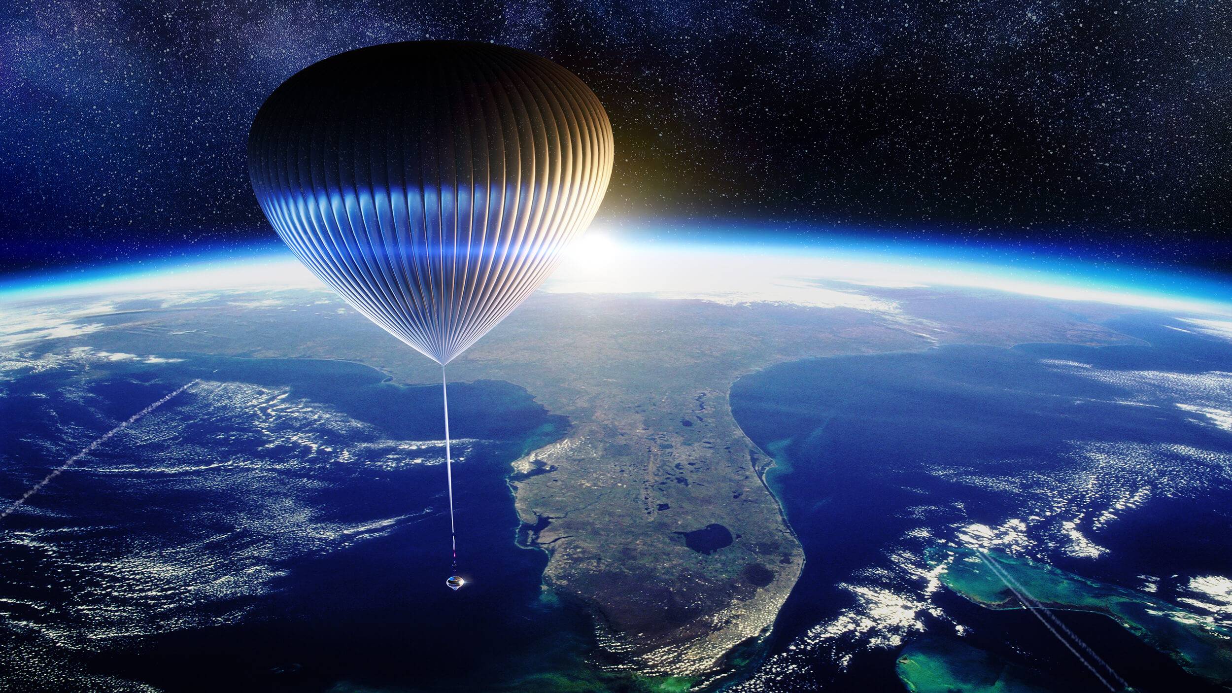 A space capsule hovering in space above the Earth's atmosphere, lifted by a large balloon