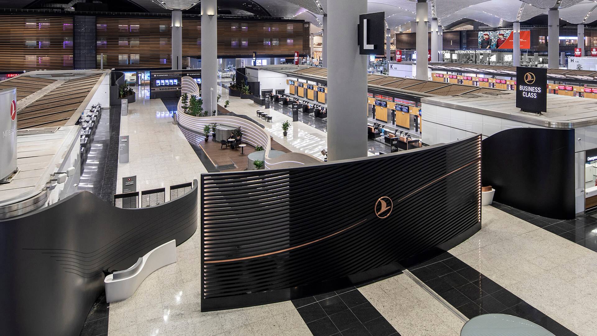 Overhead view of the vast New Istanbul Airport, featuring an imposing Business Class wall panel indicating dedicated check in area