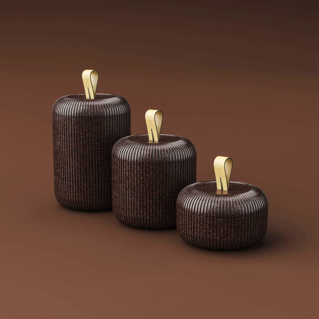 Three stacked brown bento box style containers in different sizes on a light brown background
