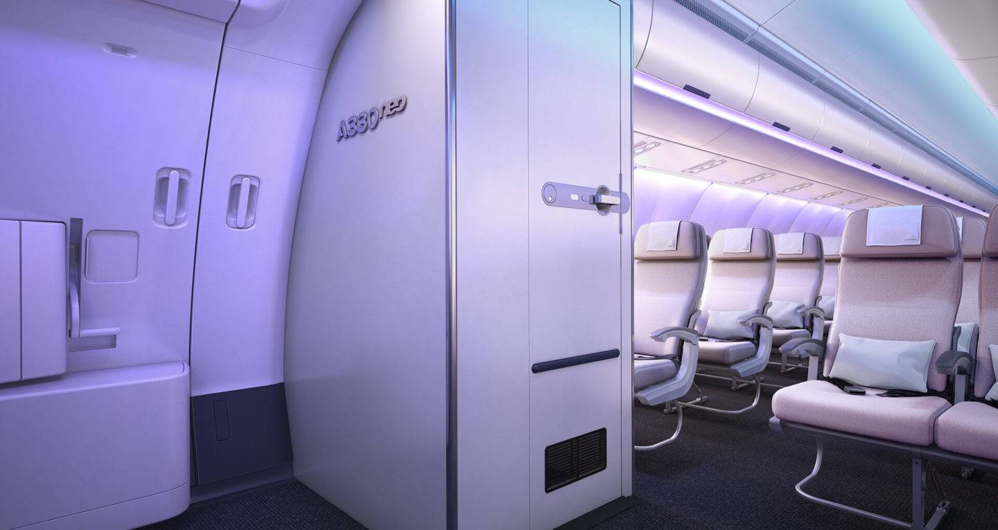 A view of the lavatory door from across the galley on the Airbus Airspace A330neo. Economy seats can be seen on the right