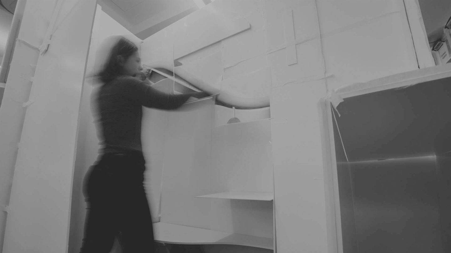 A black and white image of a person building a mockup