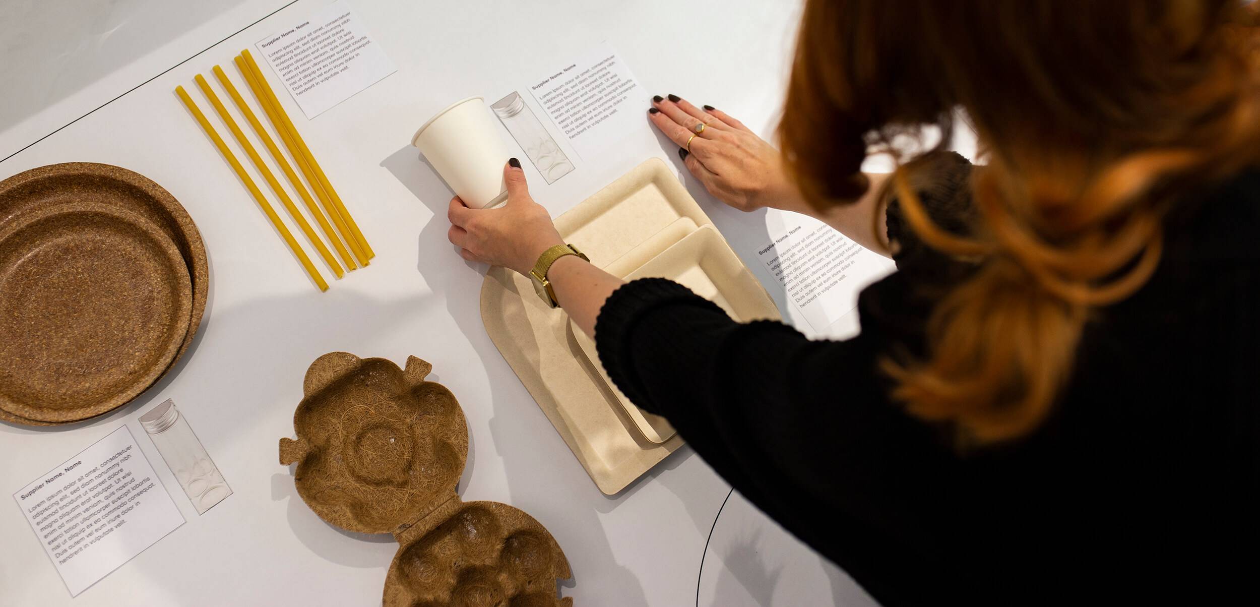 A person laying out materials for an exhibition