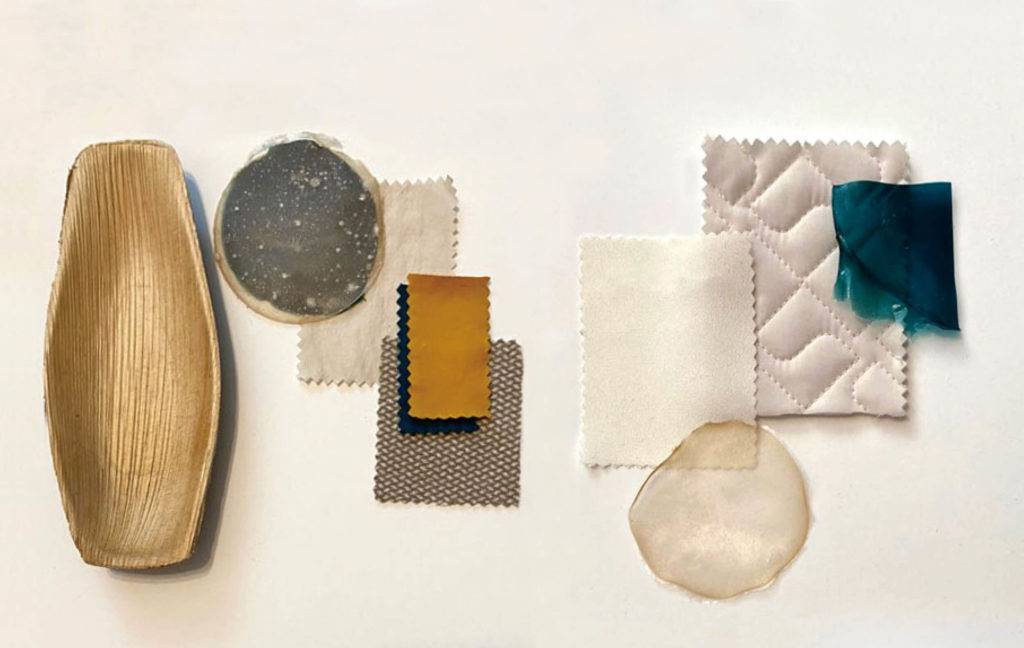 A selection of material samples including light wood, light or natural coloured fabrics and algae and plant-based materials