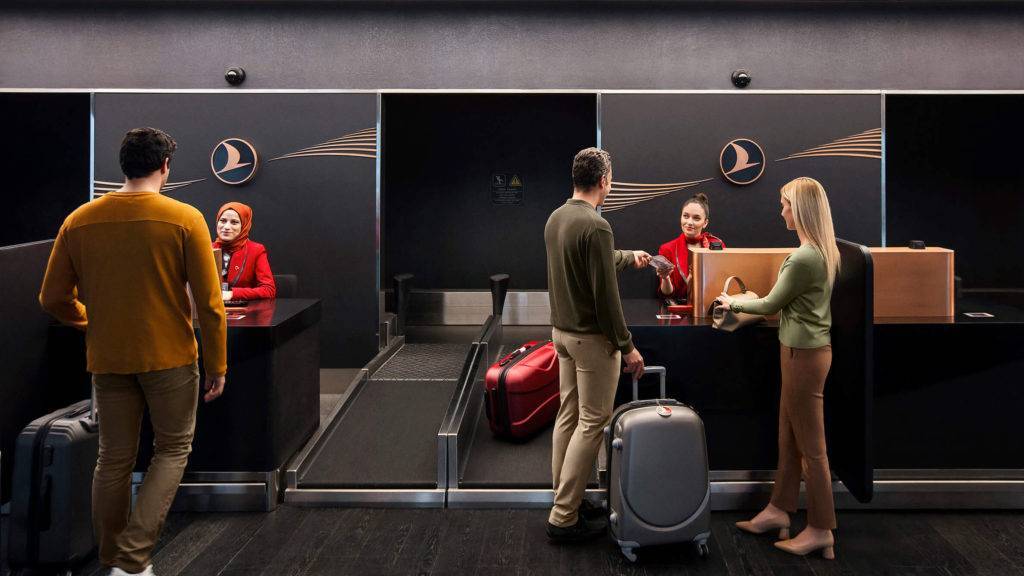 Passengers talking to staff at Turkish Airlines business class check in at New Istanbul Airport