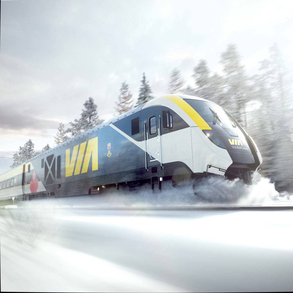 The front of a VIA train shown in snowy landscape