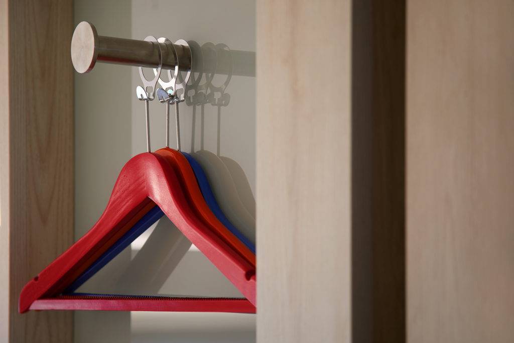 Red hangers on a coat hook
