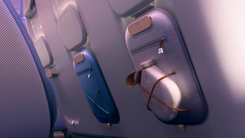 Slim bags attached to the back of an economy aircraft seat
