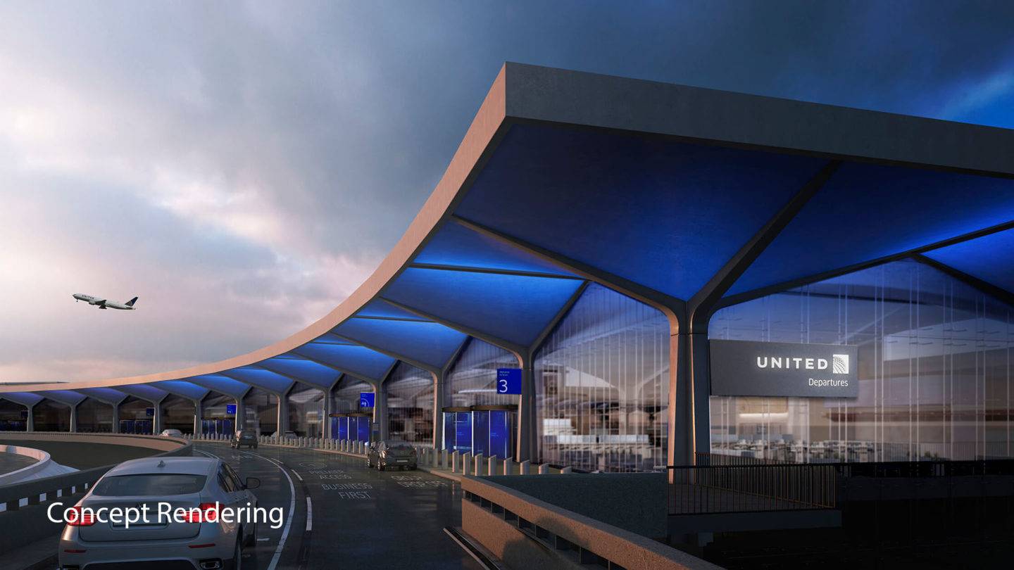 A car on a road arriving at an airport terminal building, with a lit up United Departures sign seen on the side of the building