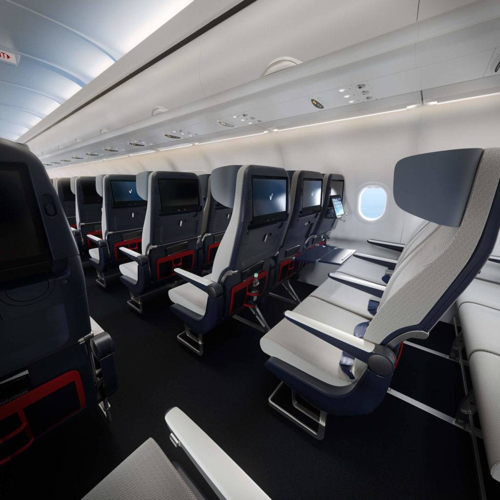 Side view of a row of economy aircraft seats showing entertainment screens