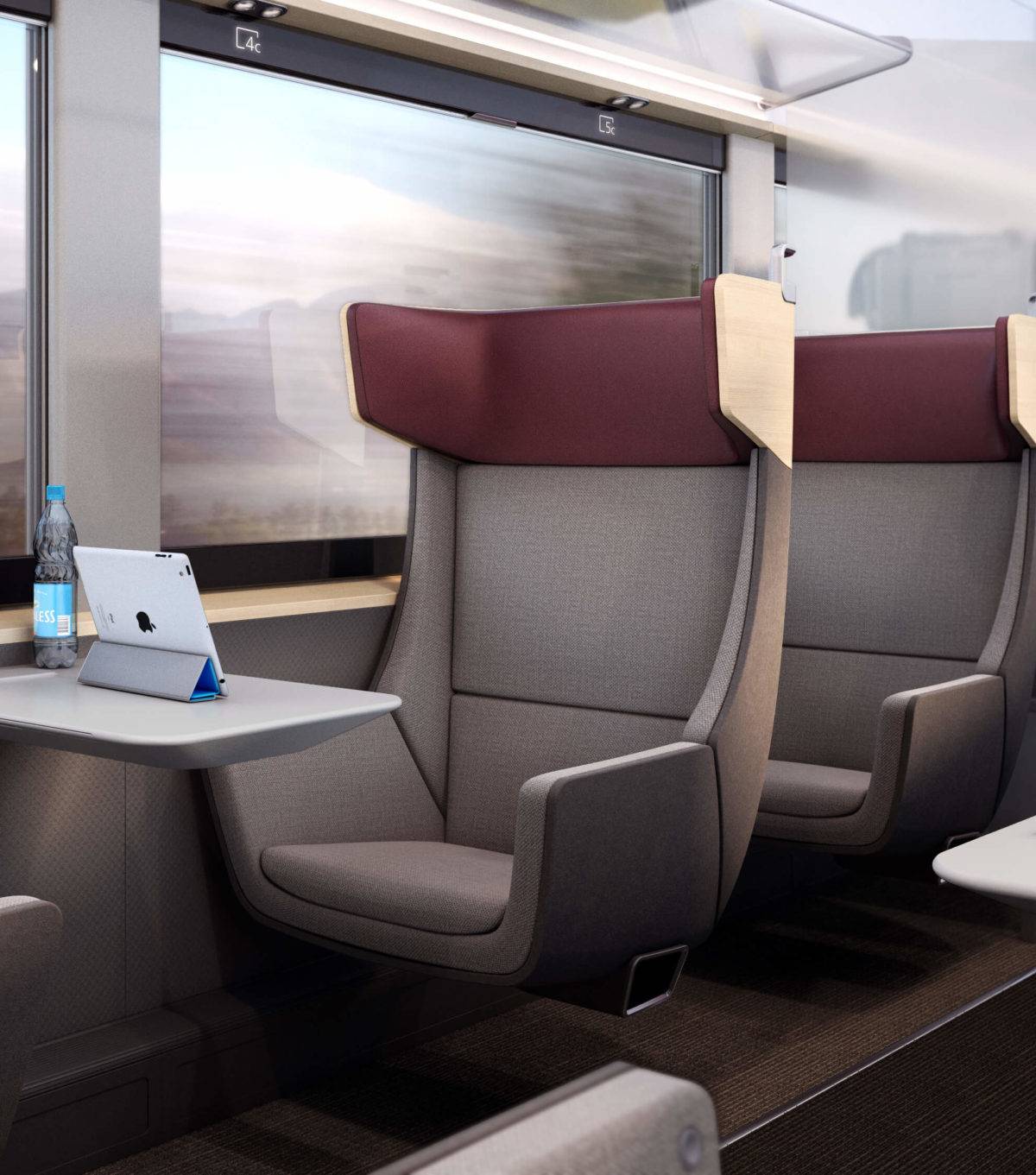 First Class train seat next to a window