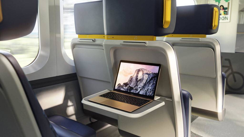 First Of A Kind rail seat with tray table down with laptop