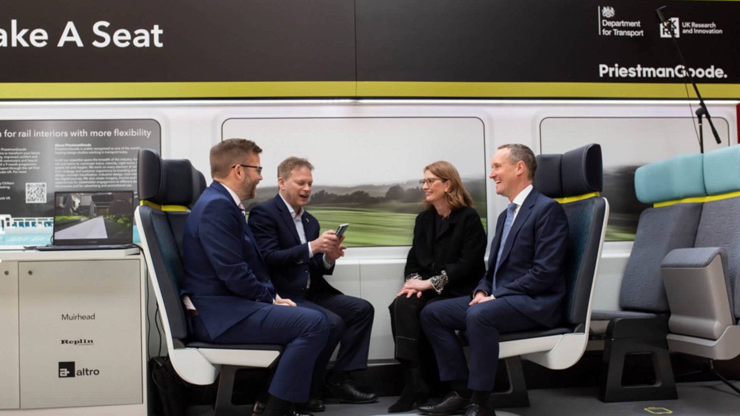 Four people sitting as a group on the FOAK Proteus demonstrator seat