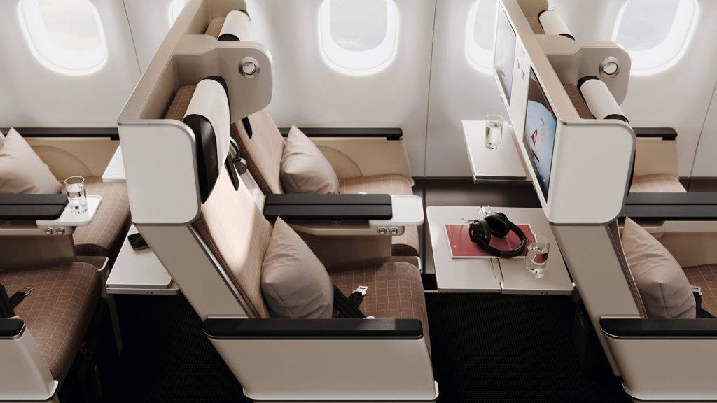SWISS Premium Economy seats with tray table down and a view from above.