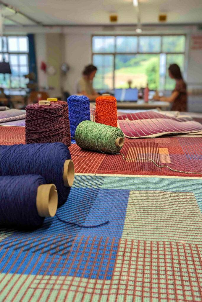 Coloured yarn shown alongside the printed carpet