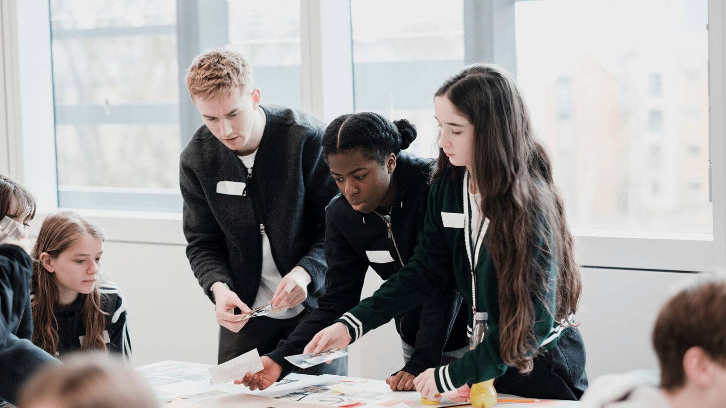 PG staff member and students placing images onto paper