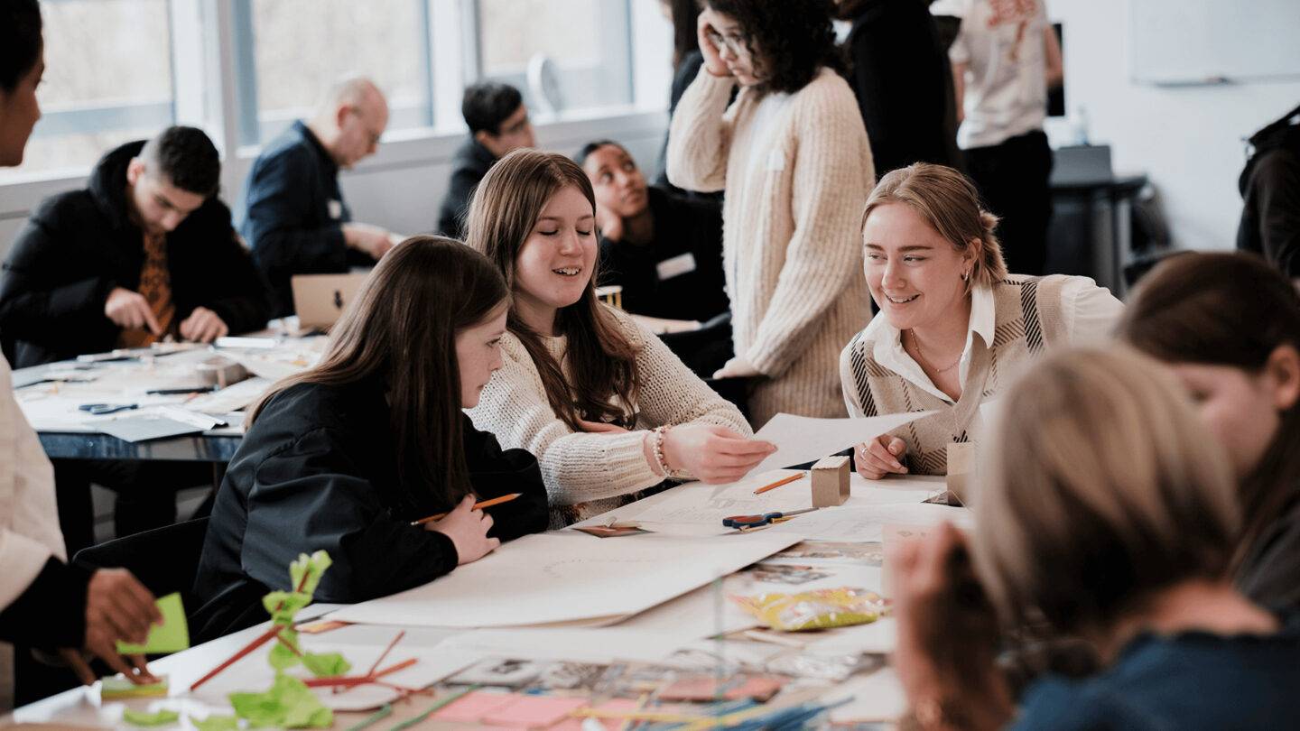 Students and PG staff discussing and drawing designs for future spaces